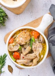 Chicken stew served in a white soup bowl.