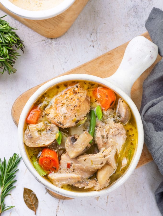 Chicken stew served in a white soup bowl.