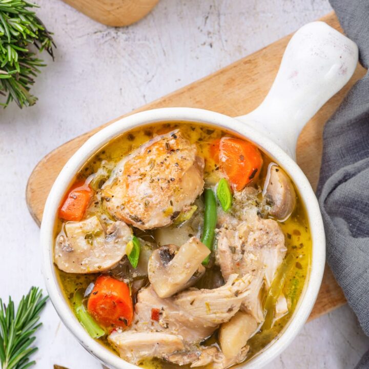 Chicken stew served in a white soup bowl.