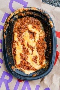 Ground beef seasoned and sauced and topped with cheese sauce.