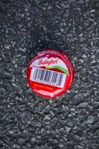 A single-serve Babybel cheese wheel.