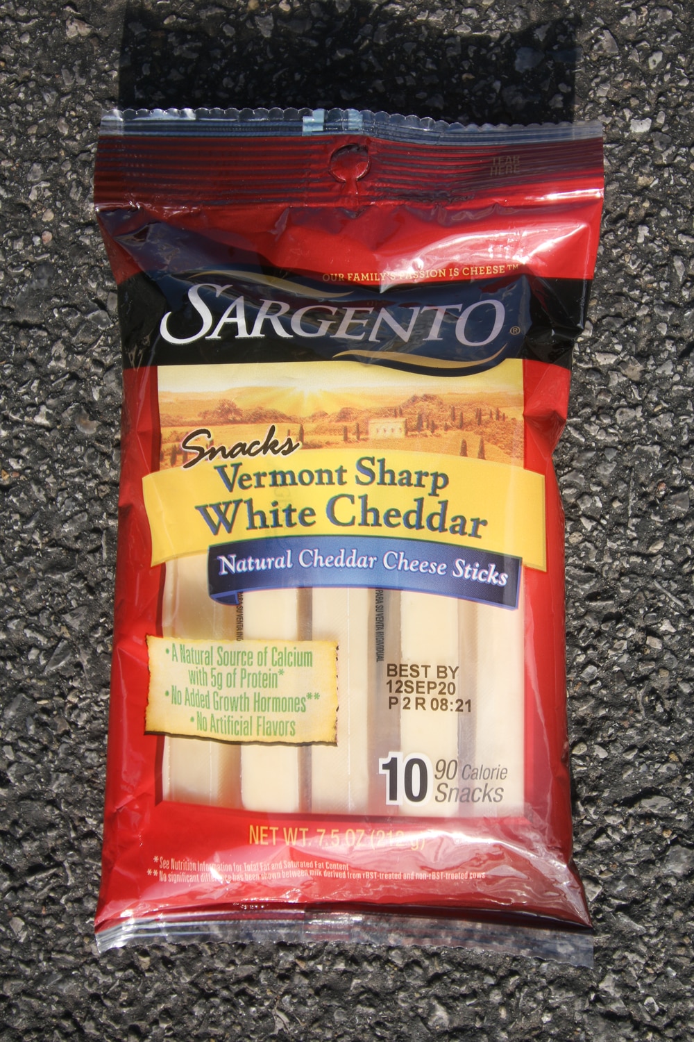 A package of white cheddar cheese sticks.