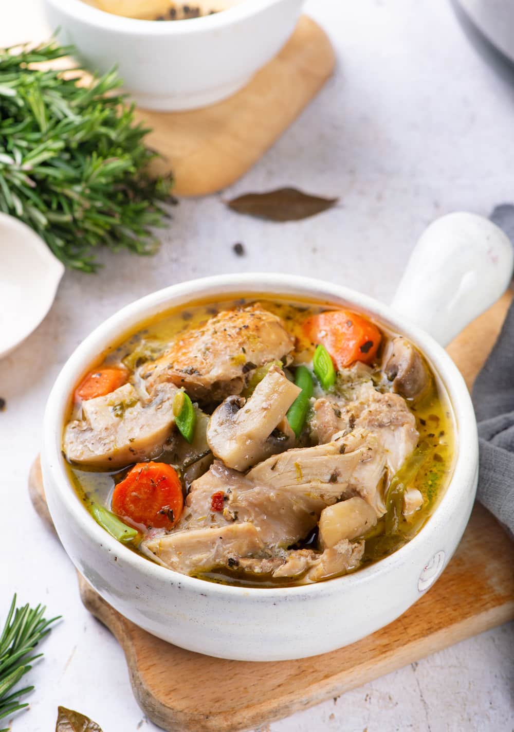 Chicken stew in a white bowl.