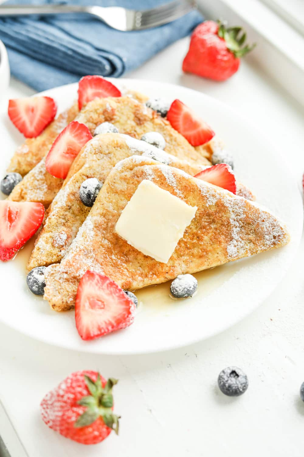 Slices of french toast on a white plate.