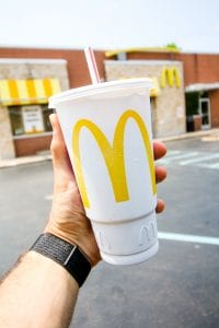 A large cup with Mcdonalds in the background.