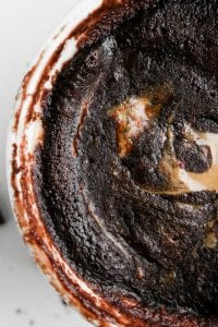 Chocolate cake with a peanut butter lava center in a white mug.