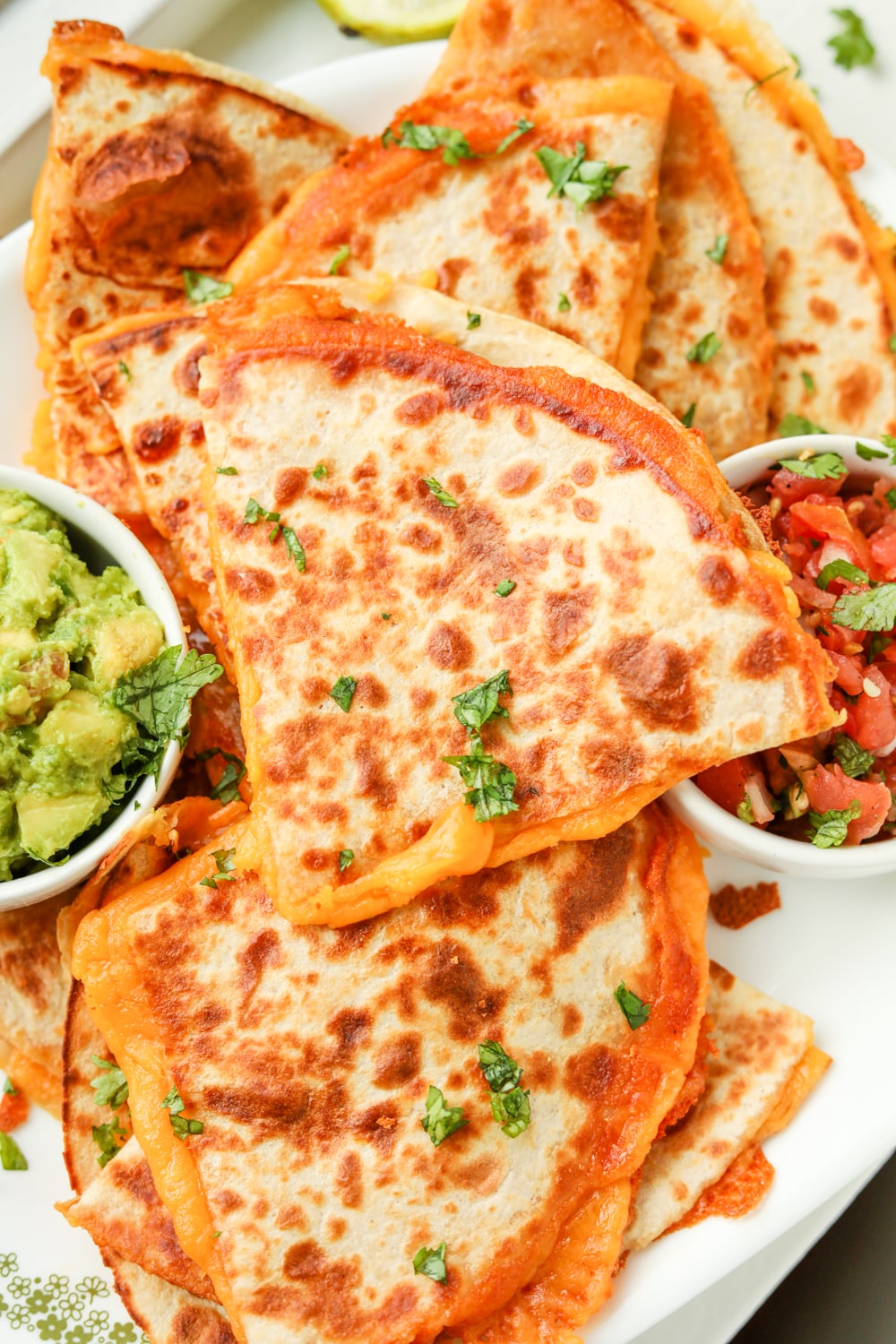 Quesadillas on a platter stacked on top of each other.