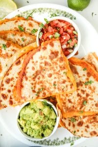 Cheese quesadillas on a white plate.