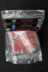 Frozen tuna filets in a clear plastic bag.