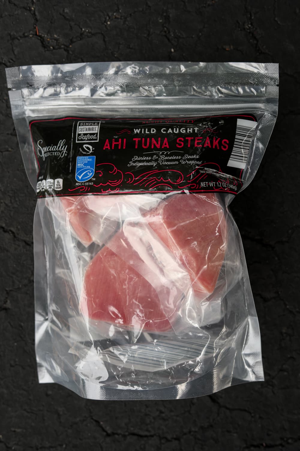 Frozen tuna filets in a clear plastic bag.