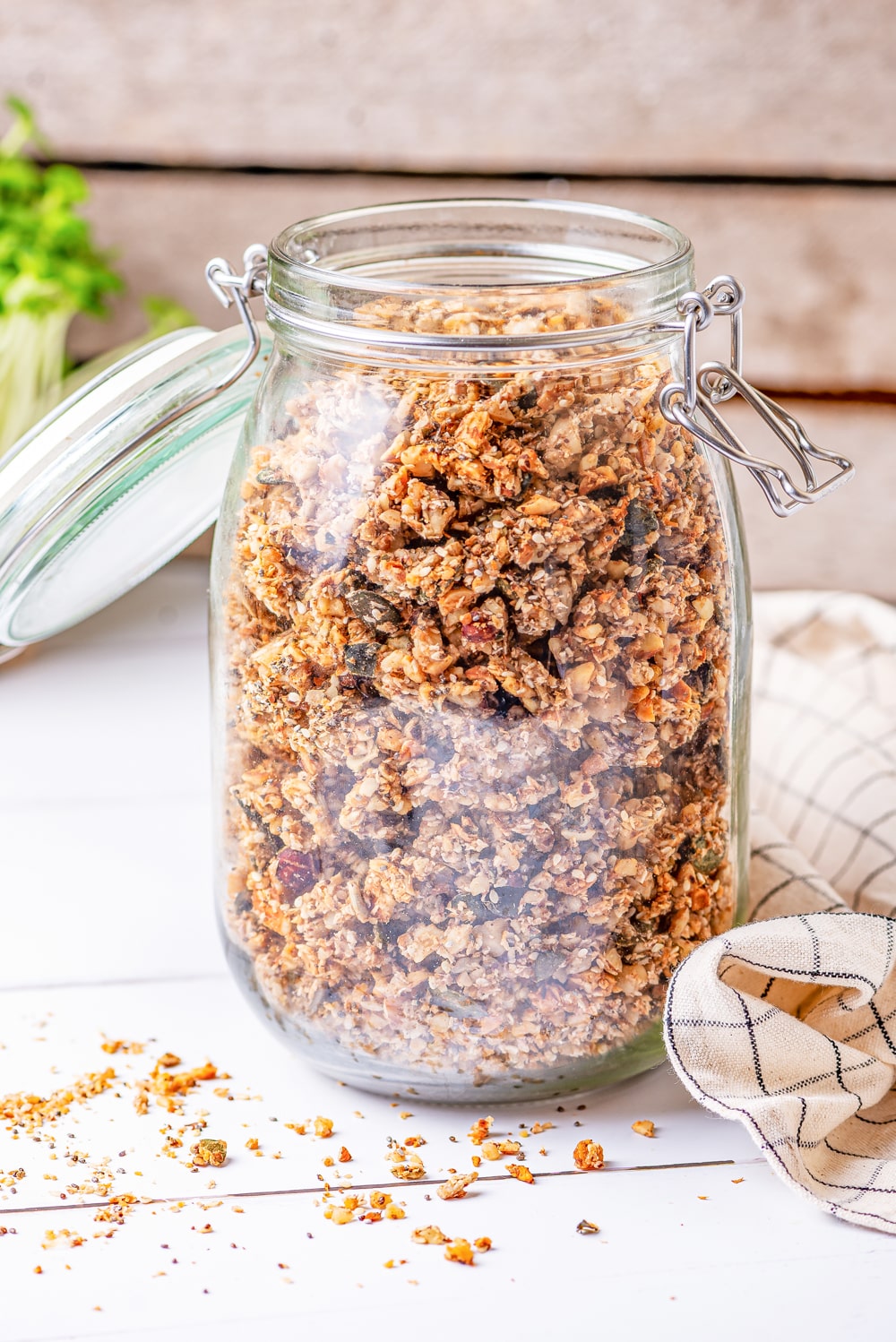 A clear glass jar filled with granola.