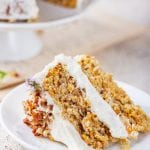 A slice of carrot cake on a white plate.