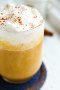 A pumpkin spice latte topped with whipped cream and spices.