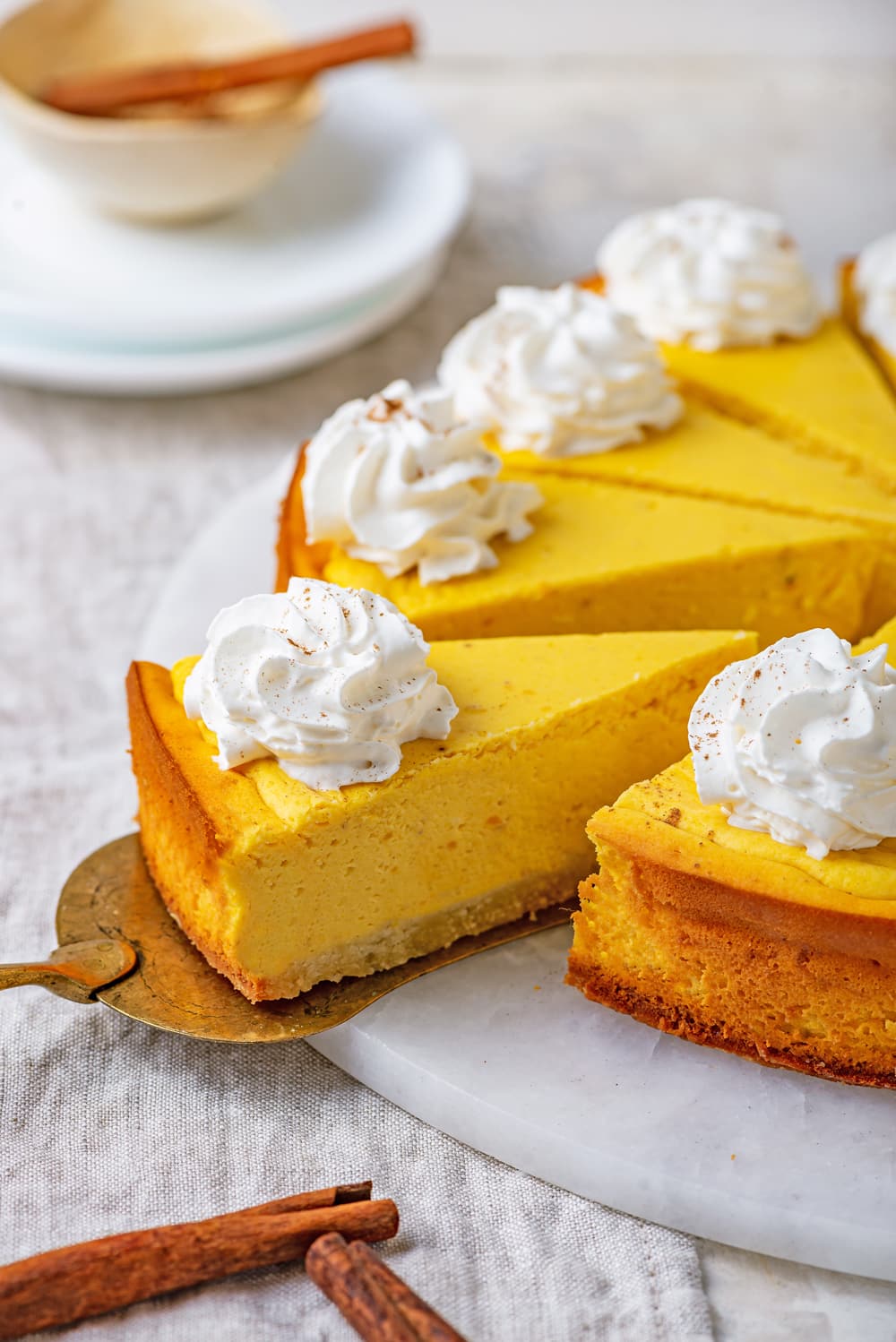 Slices of cheesecake on a white serving tray.