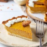 A slice of pumpkin pie on a plate.