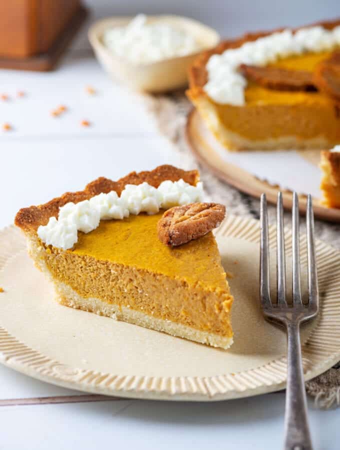 A slice of pumpkin pie on a plate.