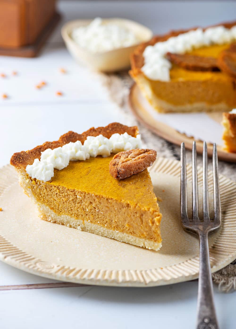 A slice of pumpkin pie on a plate.