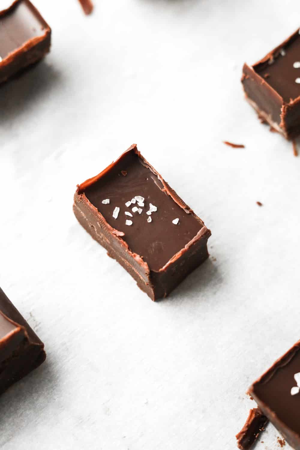 A piece of chocolate fudge on a white piece of paper.