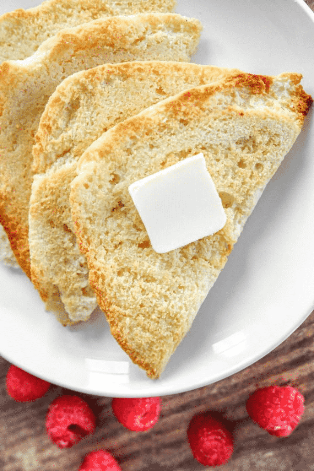 Slices of toasted bread on a white plate.