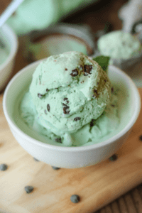 A white bowl filled with mason jar mint chocolate chip ice cream.