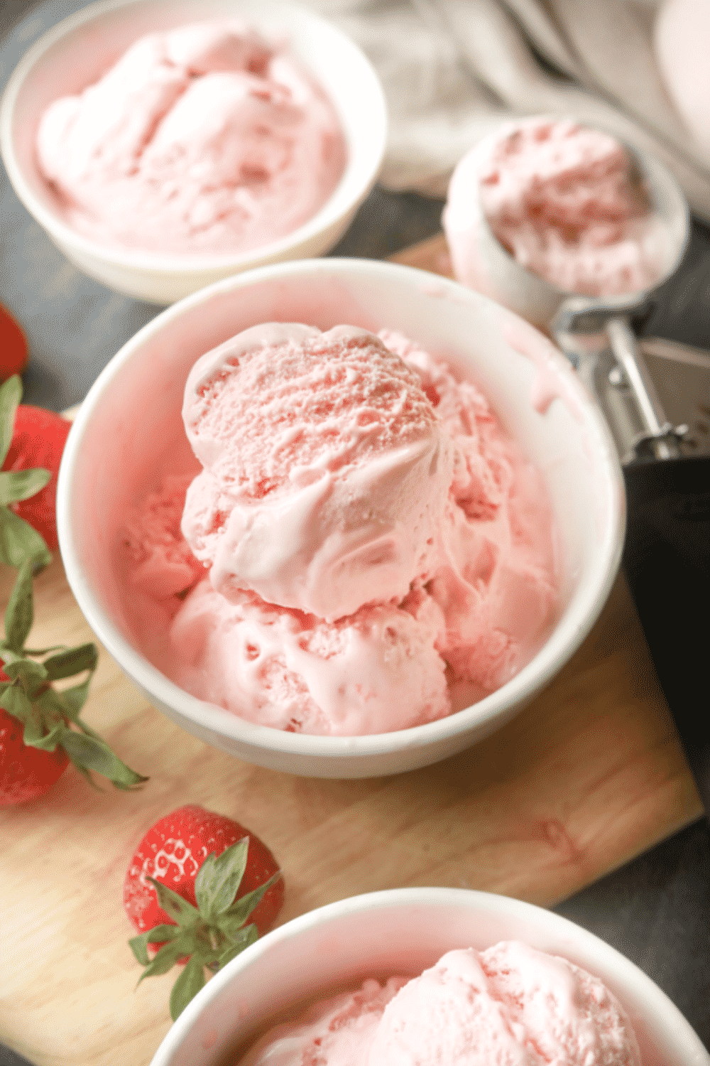 A white bowl filled with strawberry ice cream