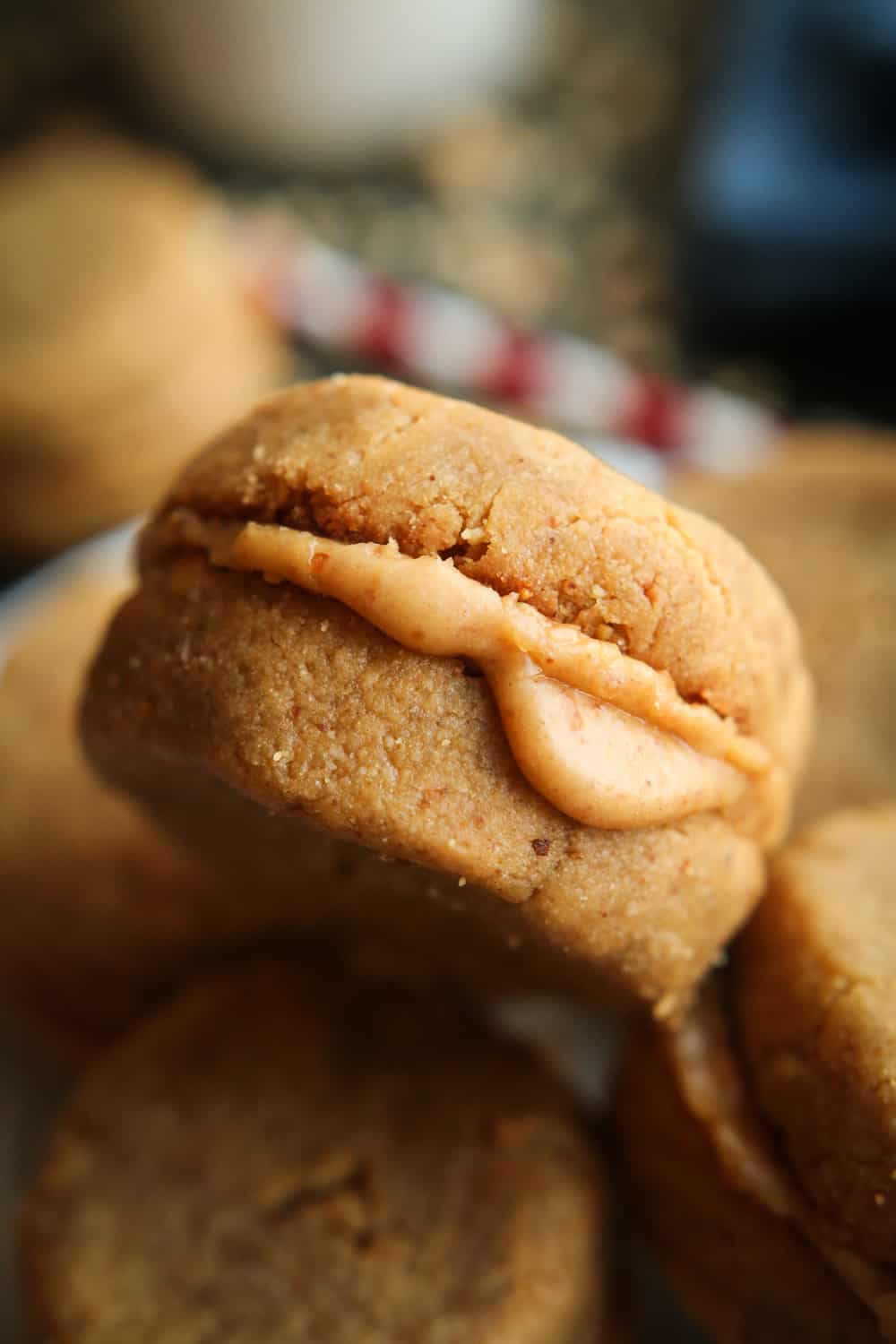 A peanut butter cookie that is placed on top of other peanut butter cookies.