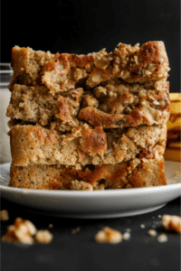 A stack of four slices of banana bread on a white plate