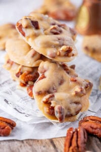 Pralines stacked on top of one another on a sheet of parchment paper.