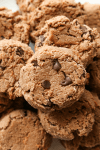 A bunch of keto chocolate cream cheese cookies on top of one another.