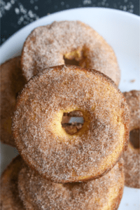 A bunch of cinnamon sugar donuts scattered on a white plate