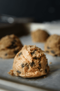 Peanut butter cookie dough fat bombs on a baking sheet.