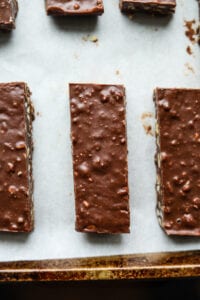 Chocolate candy bars on a baking sheet lined with parchment paper.