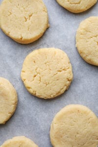 Lemon cookies on a white sheet of parchment paper.