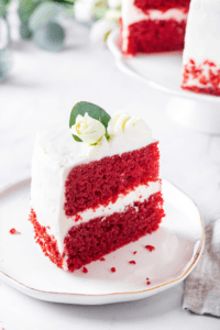 A piece of red velvet cake on a white plate.