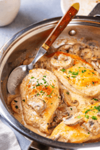 A pan filled with three pieces of chicken in a marsala sauce.