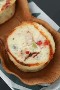 Starbucks egg white and roasted red pepper egg bites in a brown container.