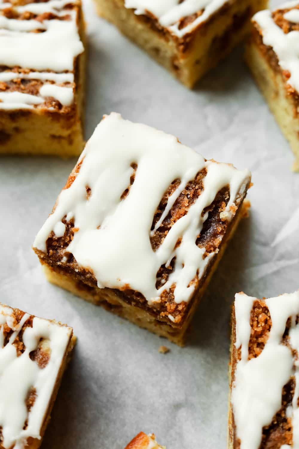 A piece of coffee cake with more pieces set beside it.