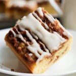 A piece of coffee cake on a white plate.