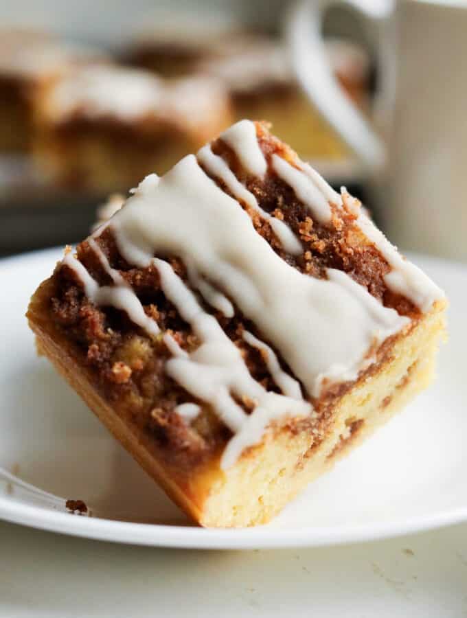 A piece of coffee cake on a white plate.