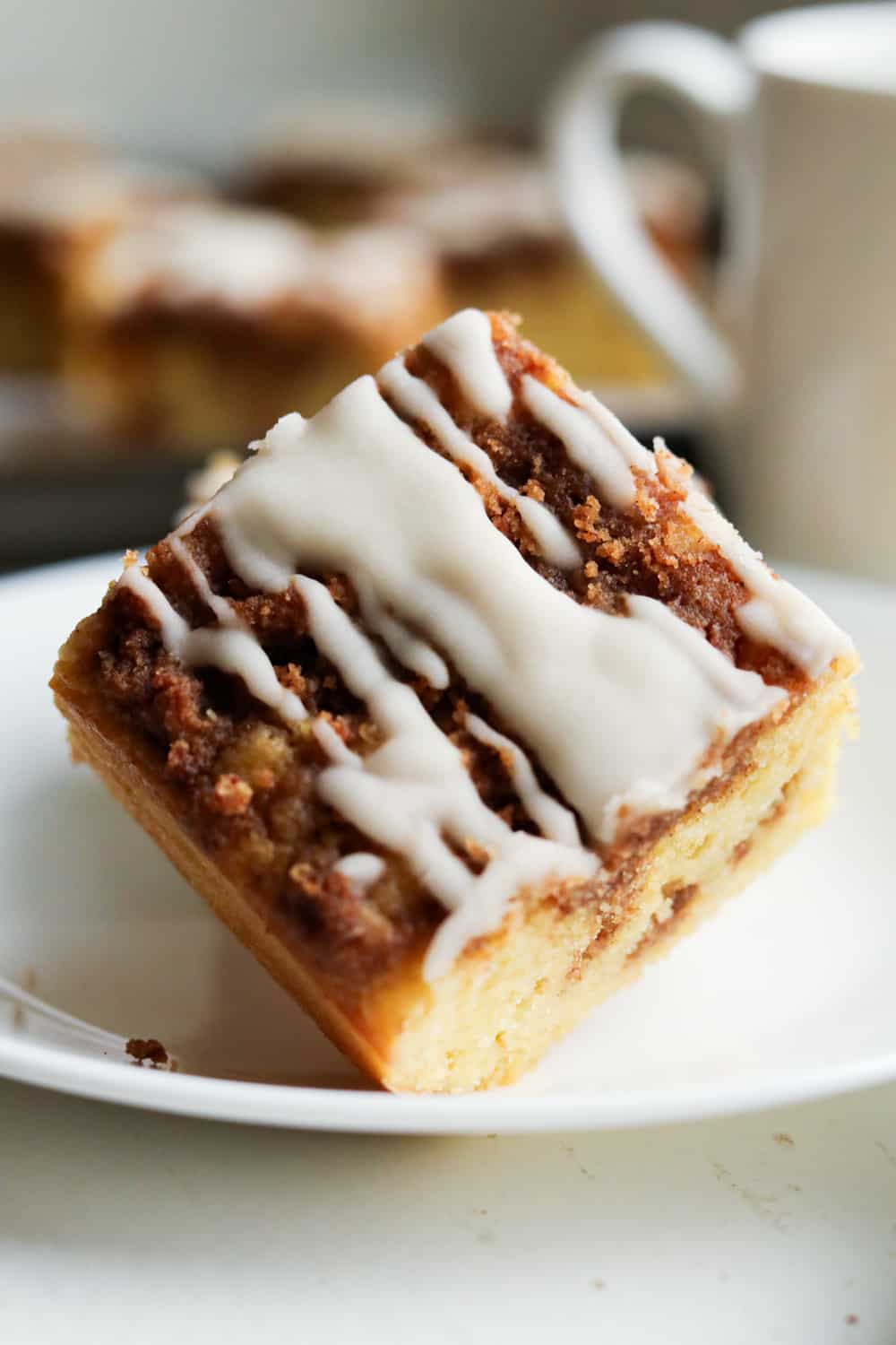 A piece of coffee cake on a white plate.