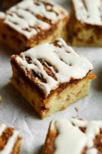 A piece of coffee cake on a baking sheet lined with white parts in paper.