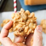 A hand holding a nut cluster.