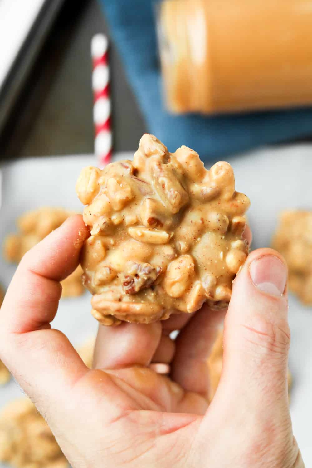 A hand holding a nut cluster.