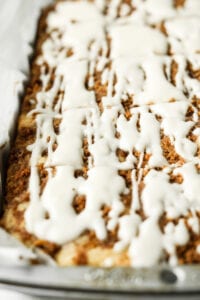 Coffee cake in a cake tray that's been lined with parchment paper.