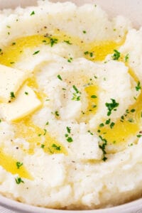 Cauliflower mashed potatoes in a white bowl.