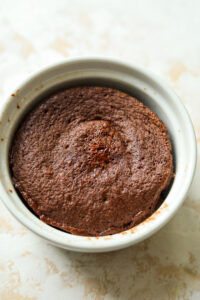 A chocolate mug cake in a white ramekin.