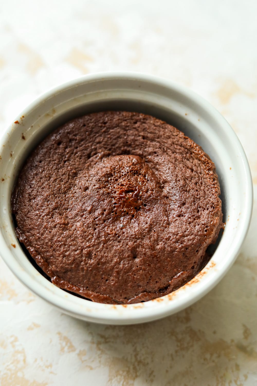 A chocolate mug cake in a white ramekin.