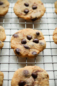 Chocolate chip cookies on a wire rack.