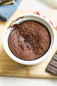 A chocolate mug cake in a white ramekin.