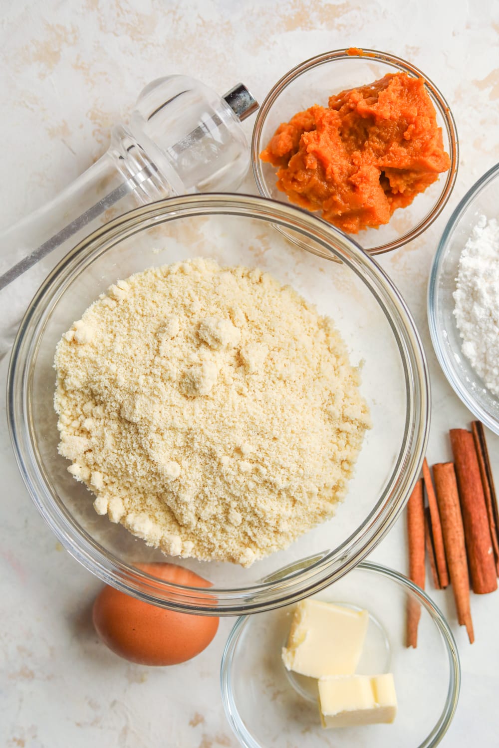 Ingredients in bowls on a white table.